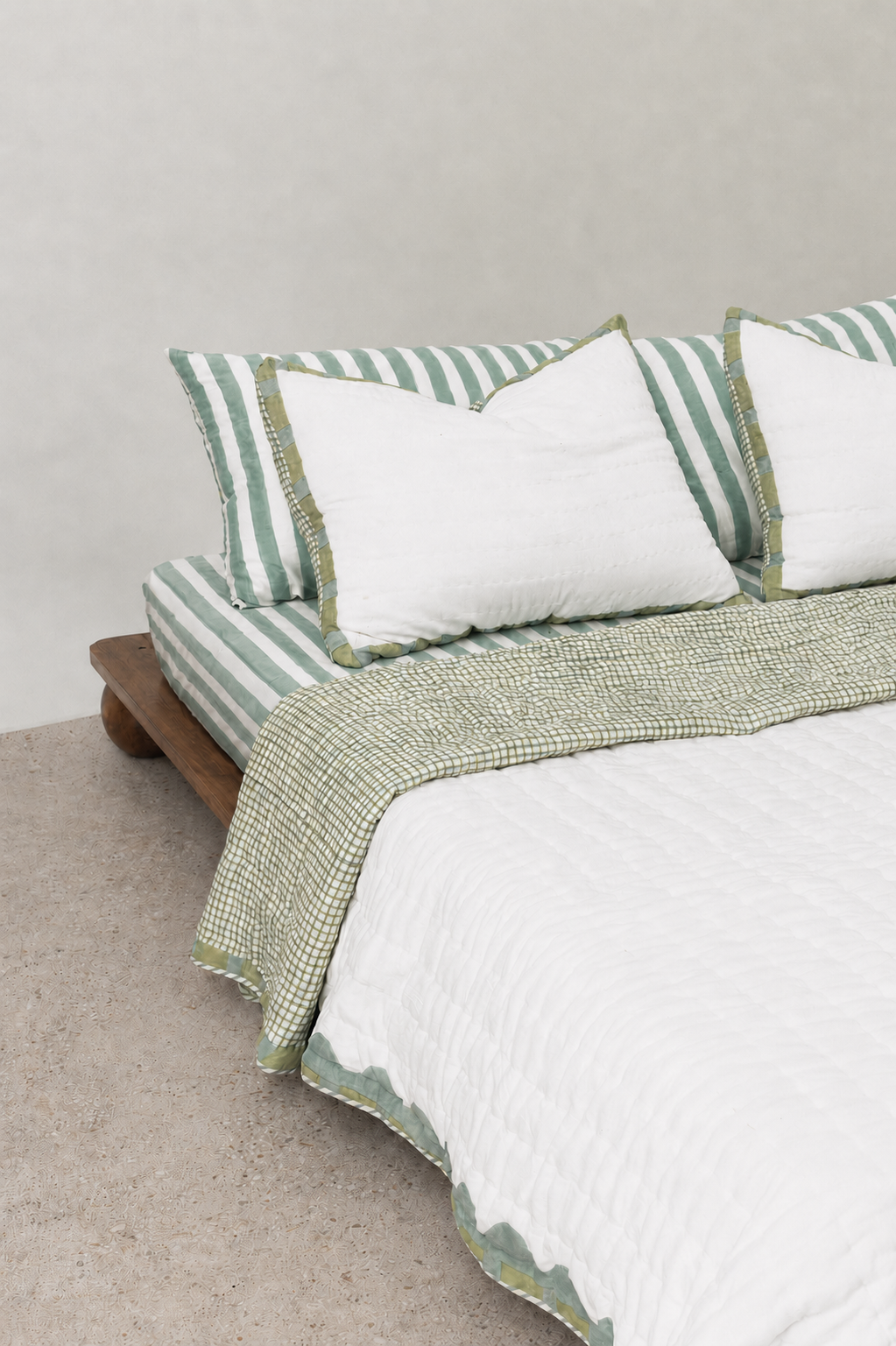 Hand block printed reversible cotton quilt with scallop border and check pattern in sage green and pastel blue. Made in Sanganer, Jaipur using 100% cotton with hand quilting.